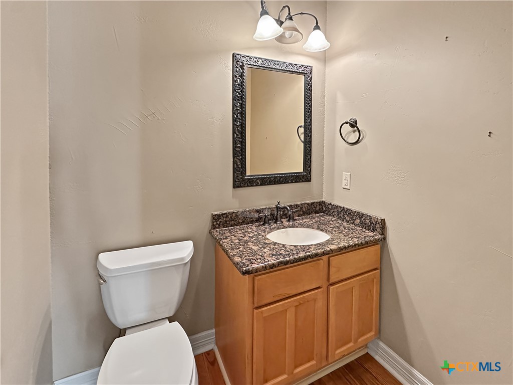 386 Wentworth Spring Branch, TX 78070 - Photo 17 of 39 a bathroom with a toilet sink and mirror