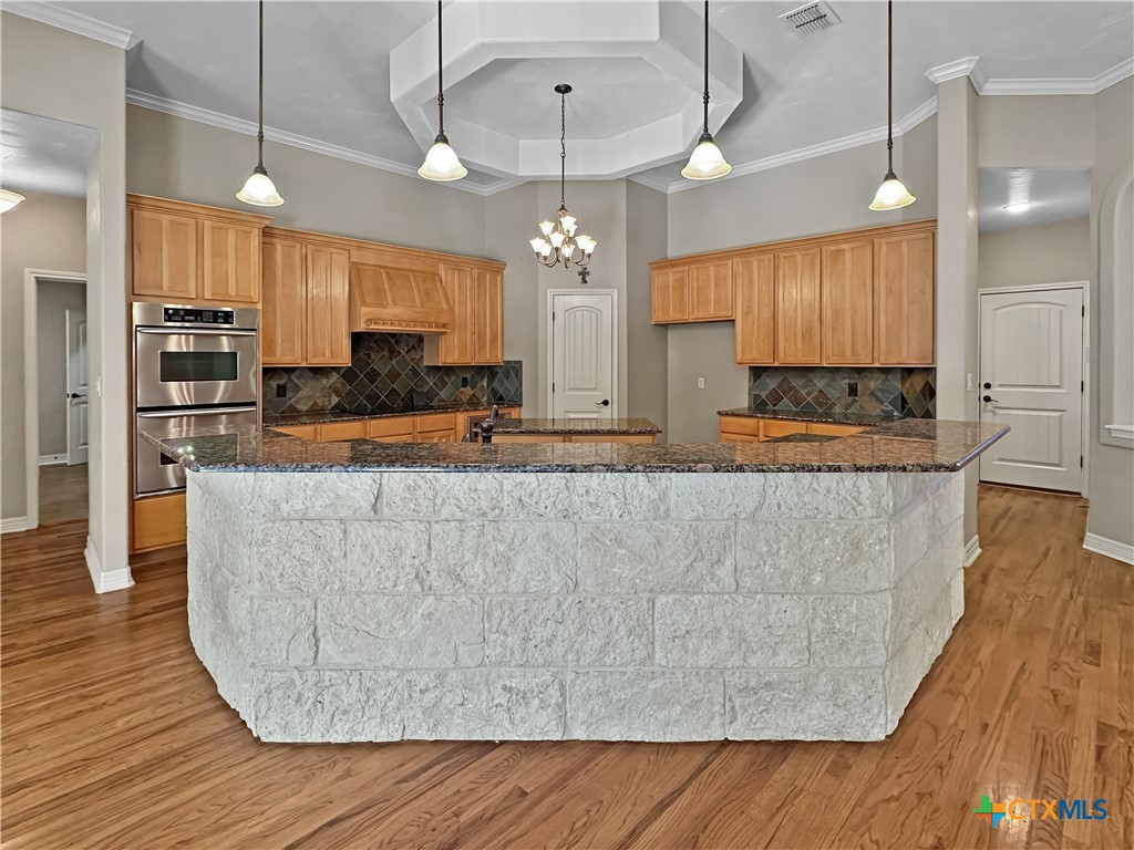 386 Wentworth Spring Branch, TX 78070 - Photo 7 of 39 a large kitchen with stainless steel appliances granite countertop a granite counter tops and a wooden floors