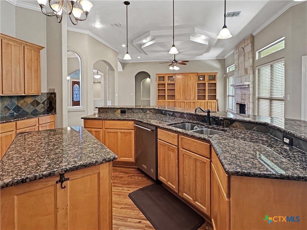 386 Wentworth Spring Branch, TX 78070 - Photo 9 of 39 a large kitchen with granite countertop a sink a counter space and stainless steel appliances