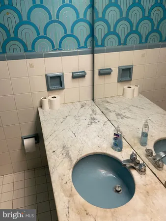 a bathroom with a sink a toilet and mirror