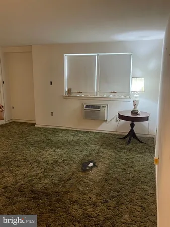 a buildings with car parked in front of it