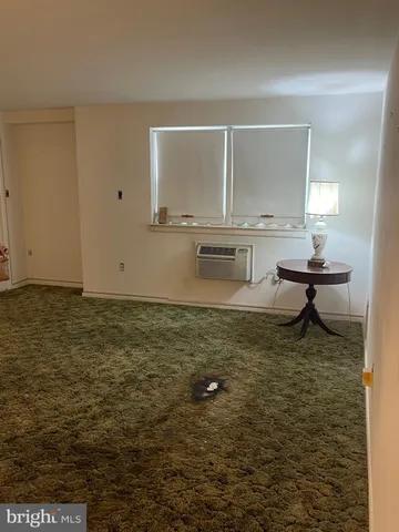 a buildings with car parked in front of it