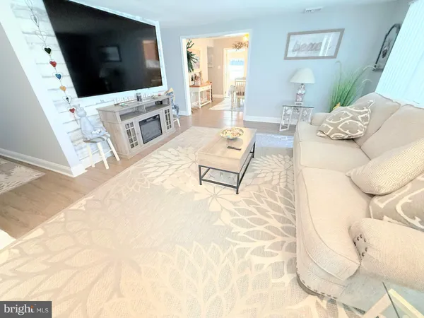 a dining room with wooden floor and windows