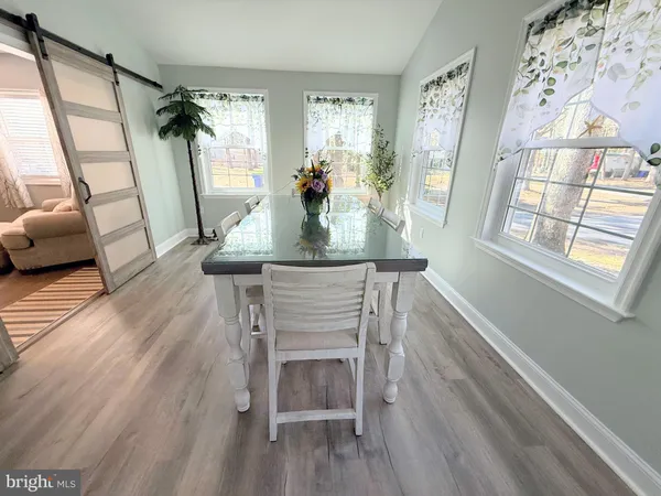 a bed sitting in a kitchen next to a window