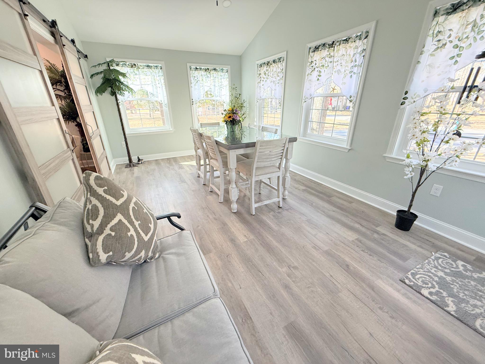 34479 Broad Water Road, Unit 644 Millsboro, DE 19966 - Photo 27 of 61 a dining room with furniture window wooden floor