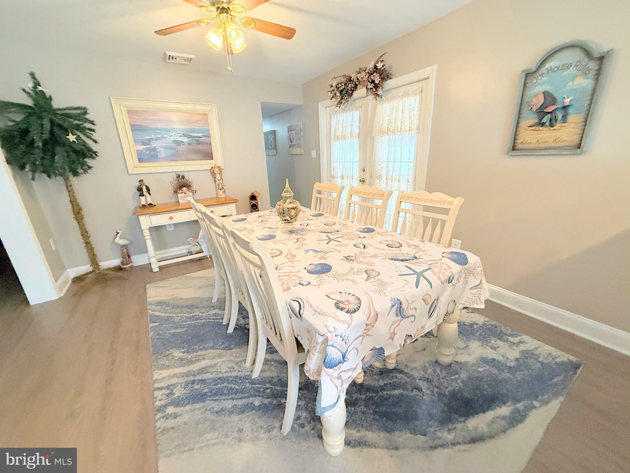 34479 Broad Water Road, Unit 644 Millsboro, DE 19966 - Photo 30 of 61 a view of a dining room with furniture window and wooden floor