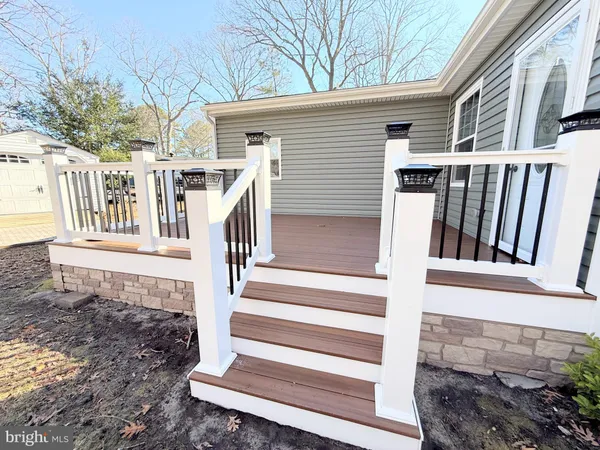 a view of a house with wooden floor and fence