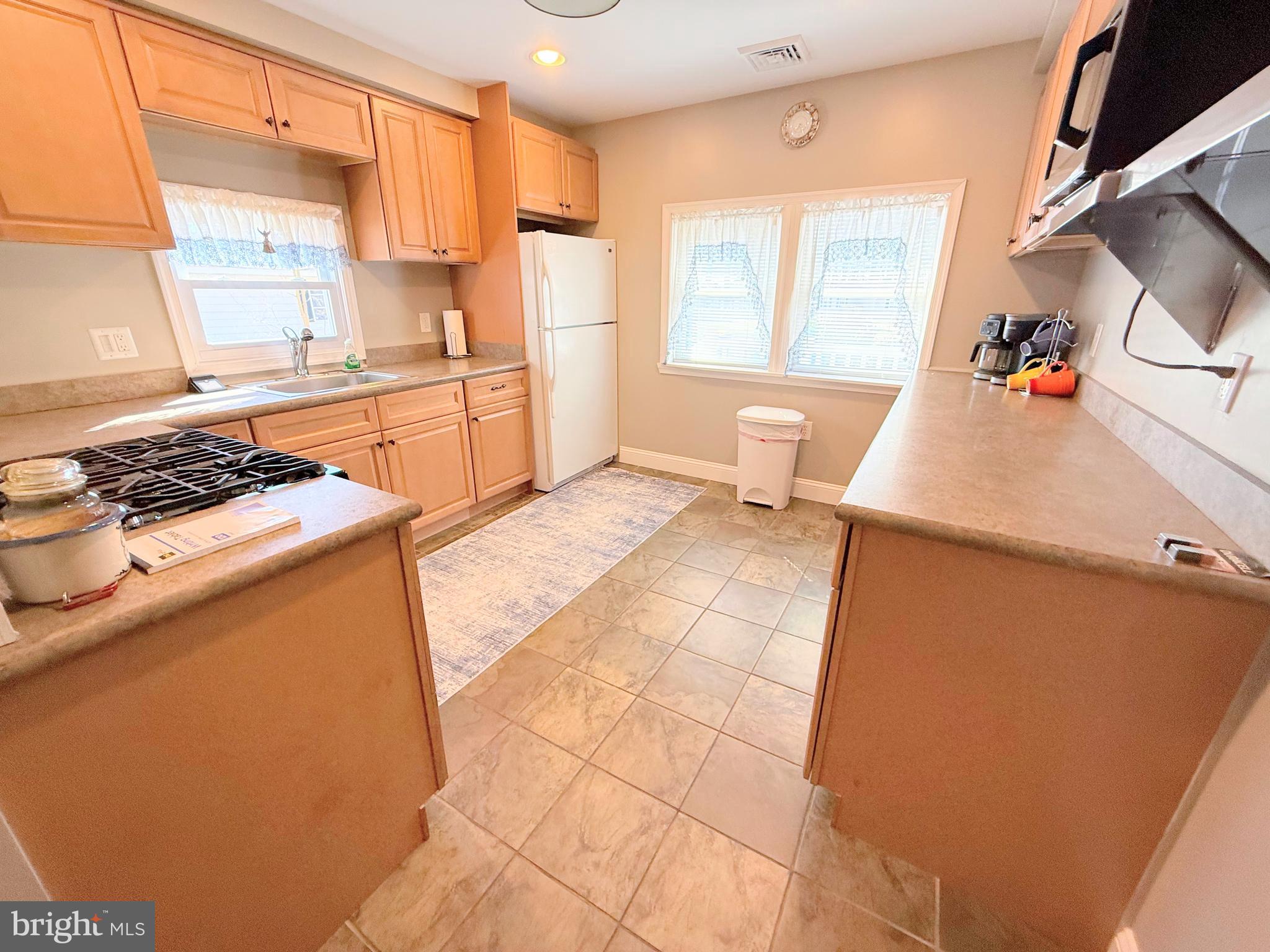 34479 Broad Water Road, Unit 644 Millsboro, DE 19966 - Photo 33 of 61 a kitchen with stainless steel appliances a stove a sink and a refrigerator