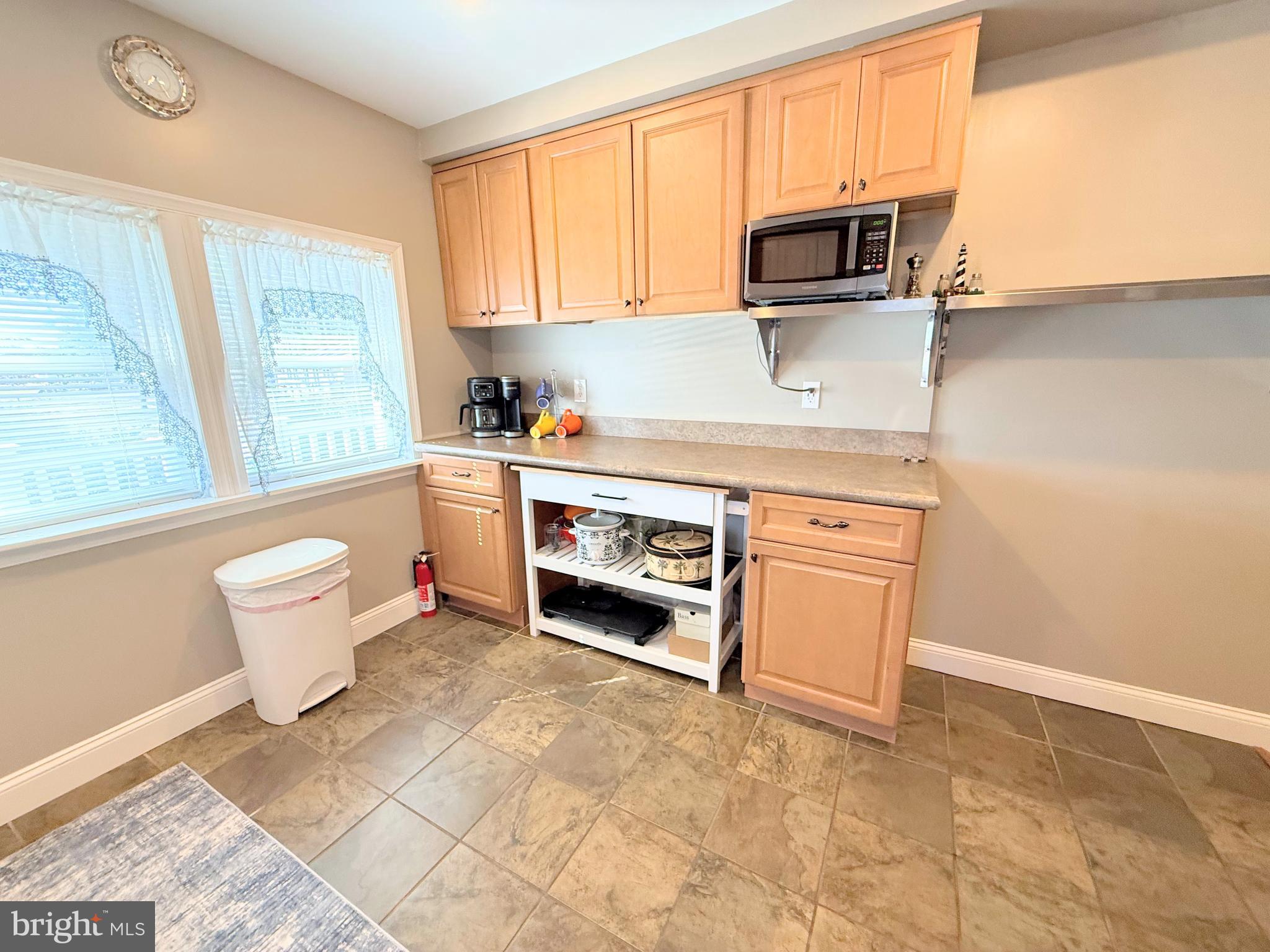 34479 Broad Water Road, Unit 644 Millsboro, DE 19966 - Photo 35 of 61 a kitchen with stainless steel appliances a stove microwave and sink