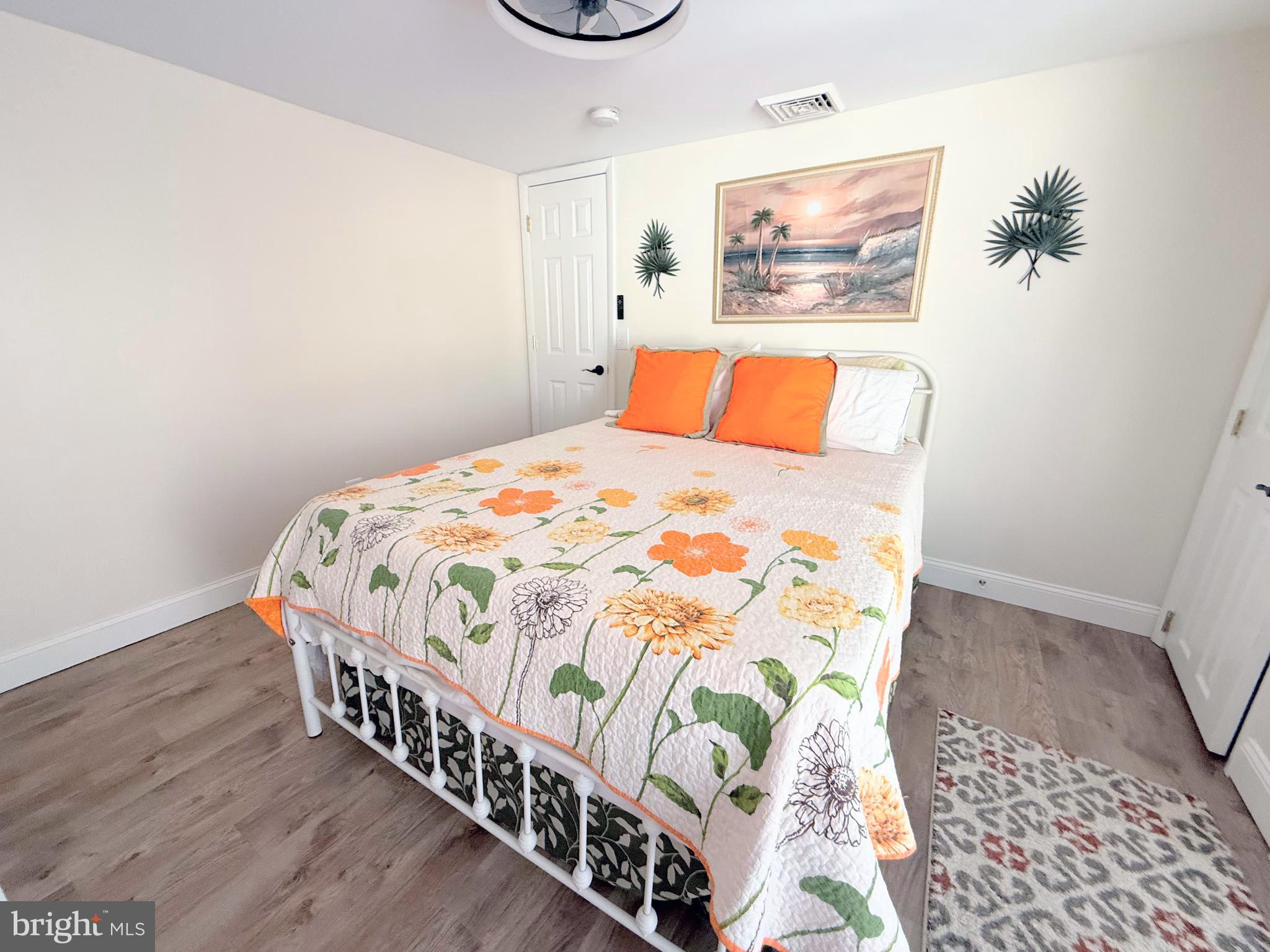 34479 Broad Water Road, Unit 644 Millsboro, DE 19966 - Photo 37 of 61 a bedroom with a bed and a painting on the wall