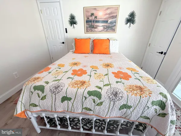 a bedroom with a bed a flat screen tv and a a couch