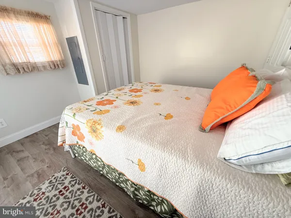 a bedroom with bed and a chair