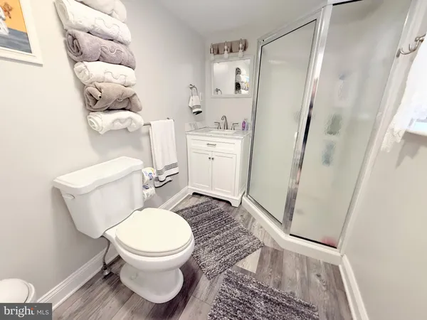 a bedroom with a bed and a lamp on dresser