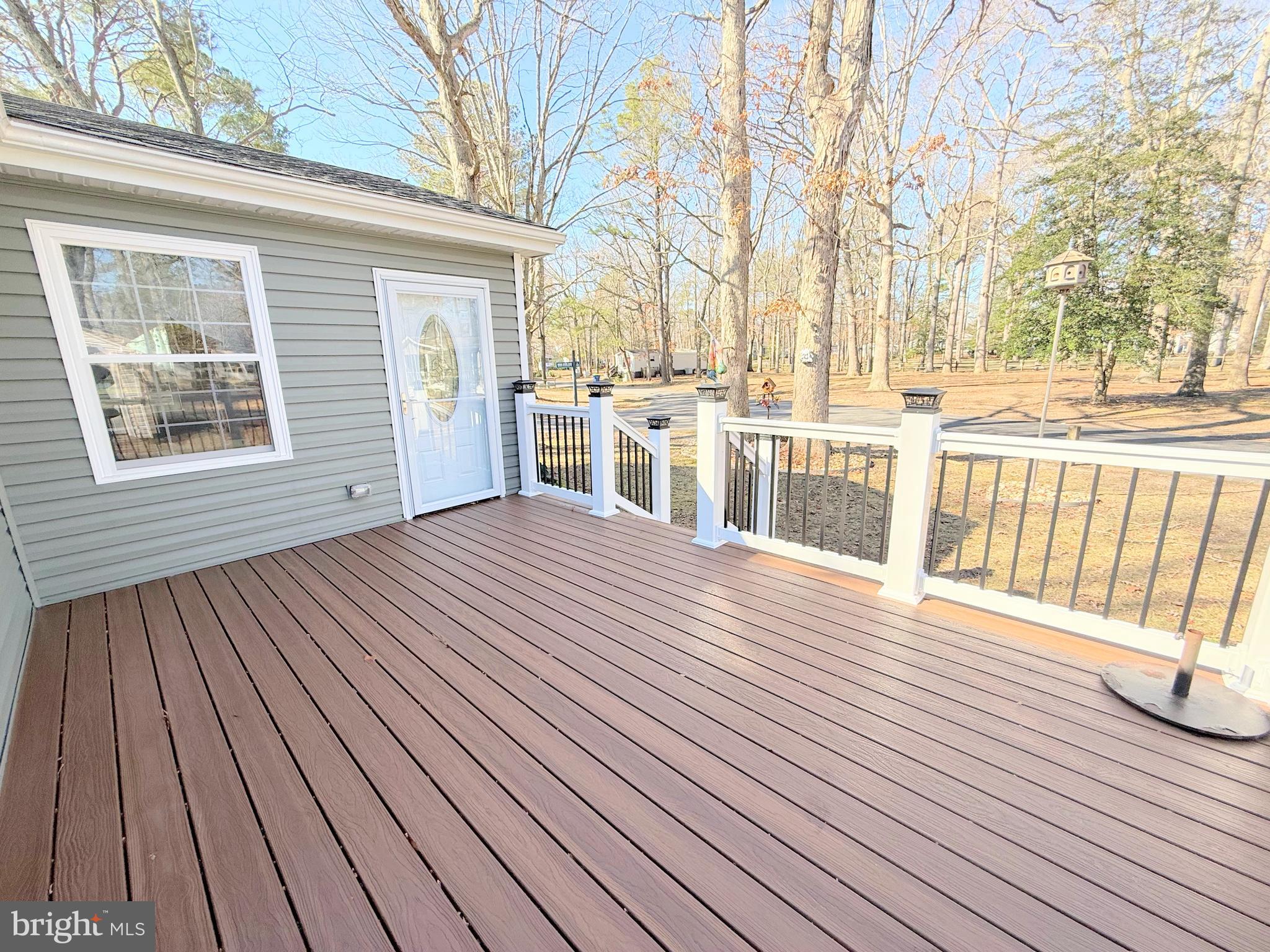 34479 Broad Water Road, Unit 644 Millsboro, DE 19966 - Photo 4 of 61 a view of a patio with wooden floor and fence