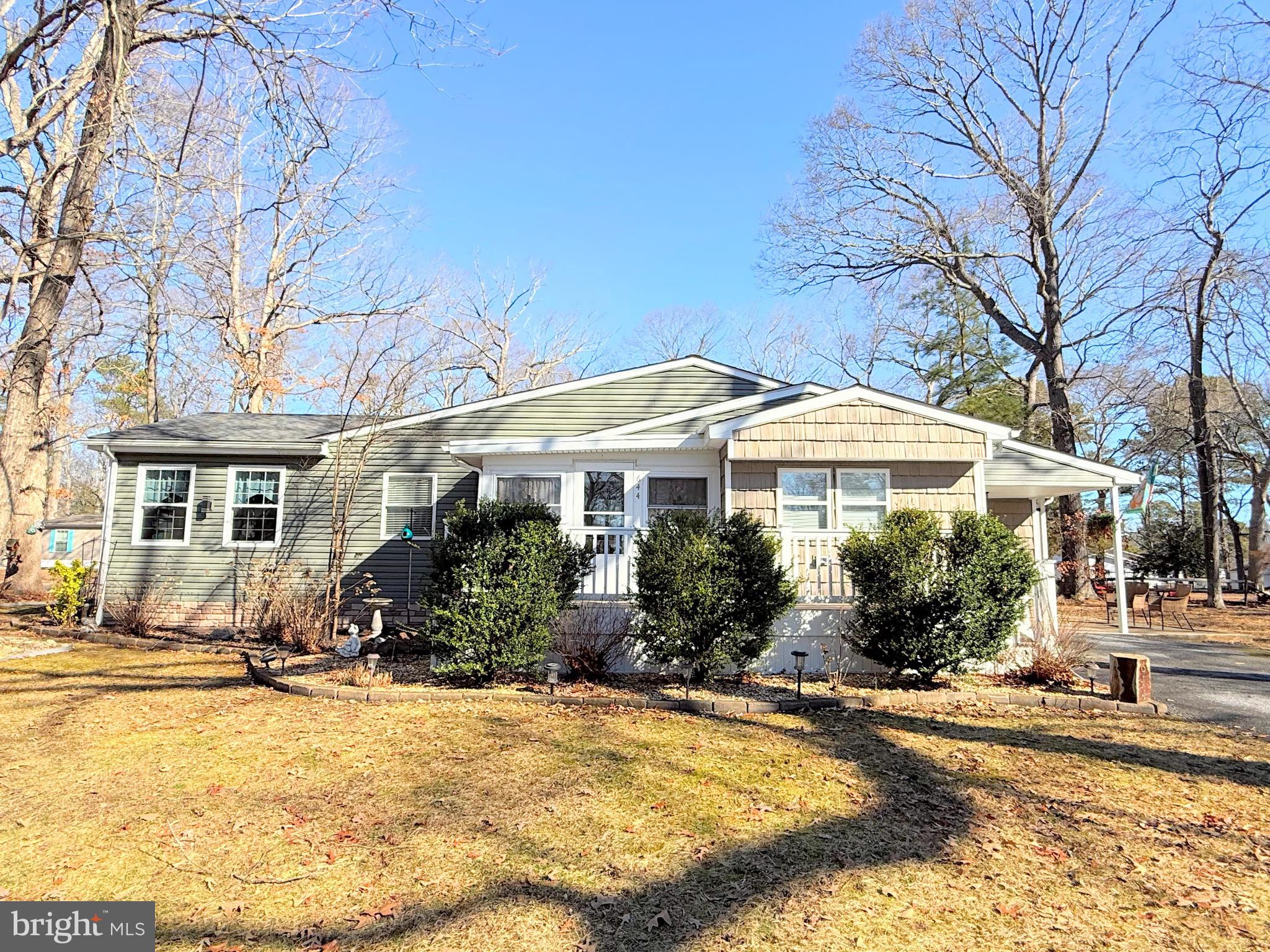 34479 Broad Water Road, Unit 644 Millsboro, DE 19966 - Photo 5 of 61 a front view of a house with yard and sitting area