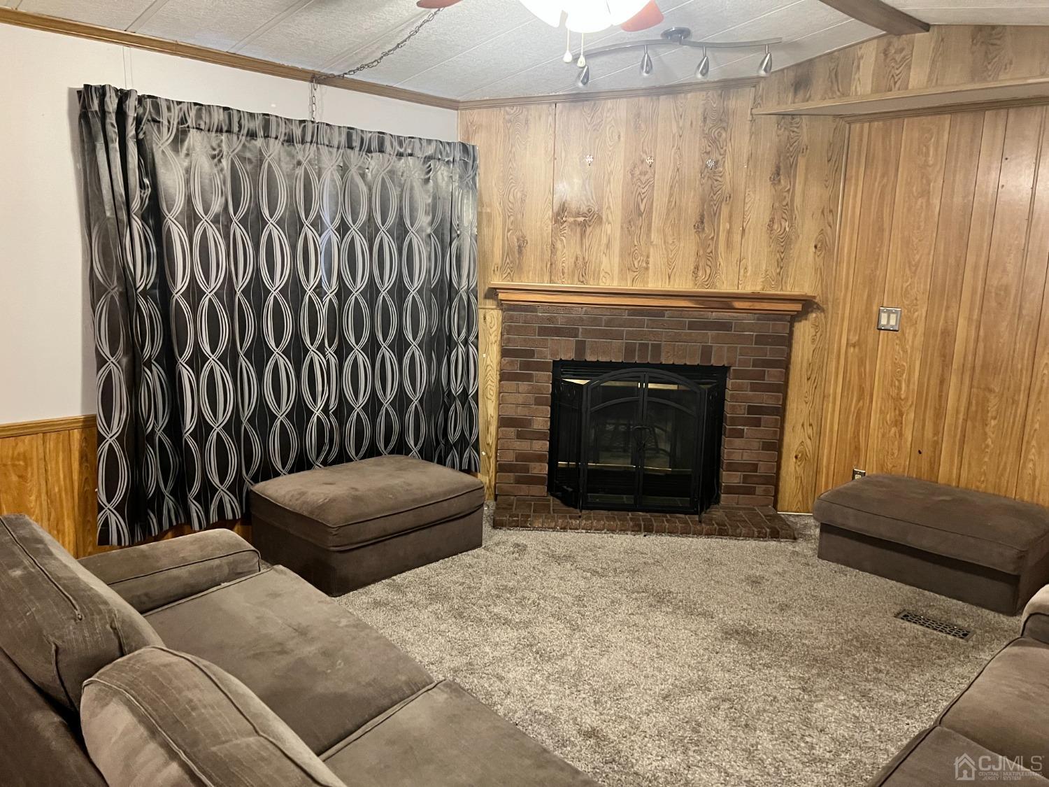 33 Poe Road North Brunswick, NJ 08902 - Photo 5 of 13 a living room with furniture and a fireplace