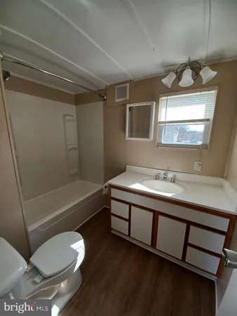 a bathroom with a sink a toilet and bathtub