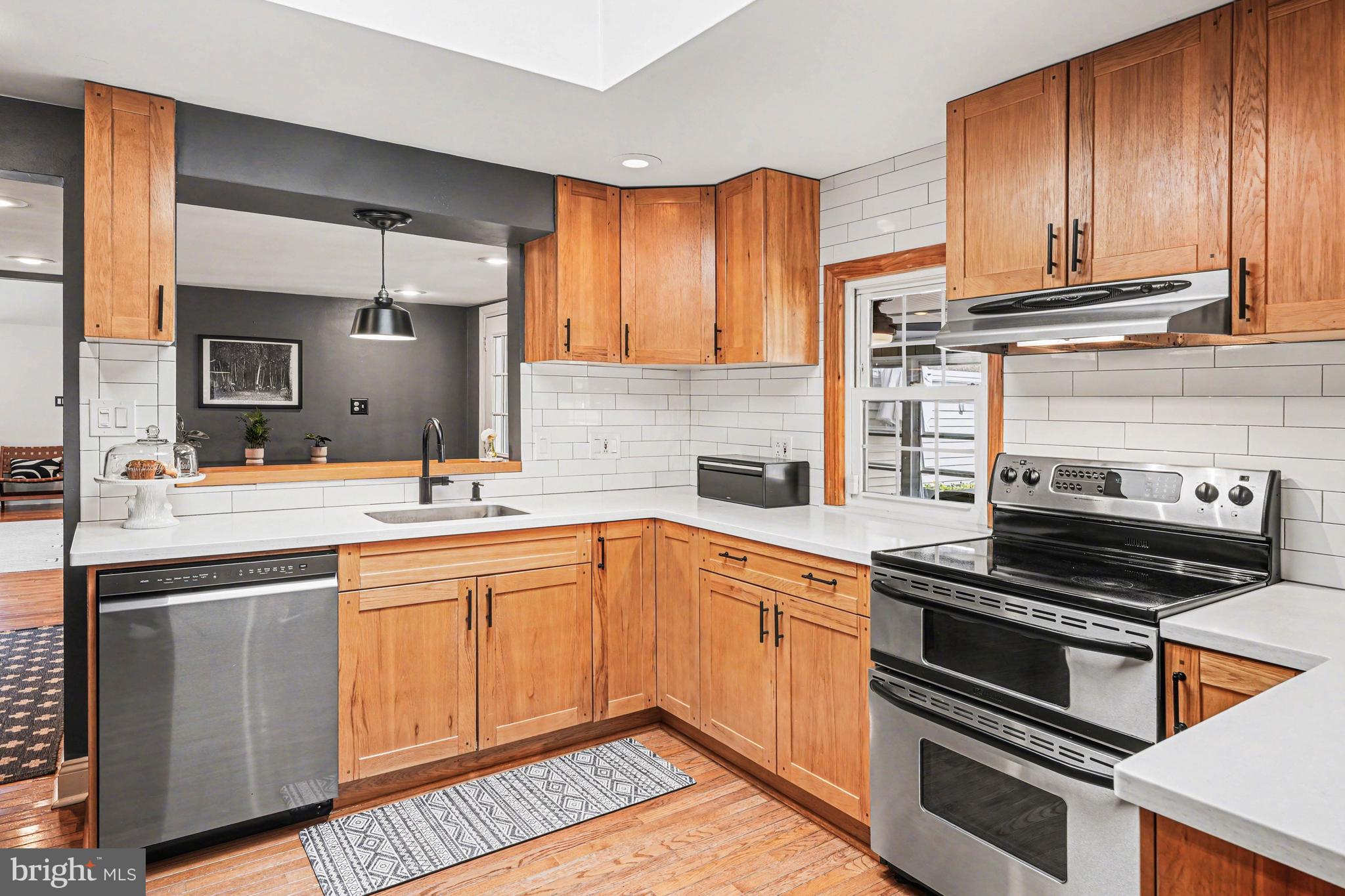 1408 Evans Road Ambler, PA 19002 - Photo 15 of 61 a kitchen with wooden cabinets and a stove top oven