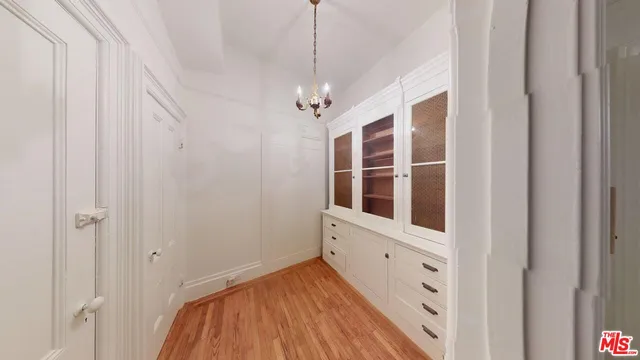 a view of a hallway with wooden floor and entryway