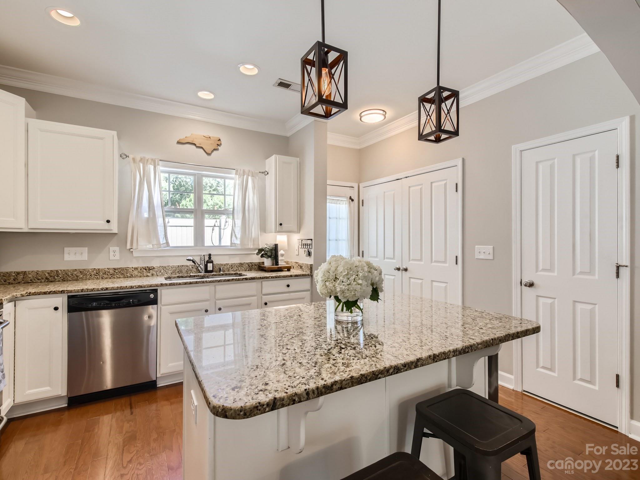 831 Millbrook Road Charlotte, NC 28211 - Photo 13 of 33 a kitchen with center island cabinets and wooden floor