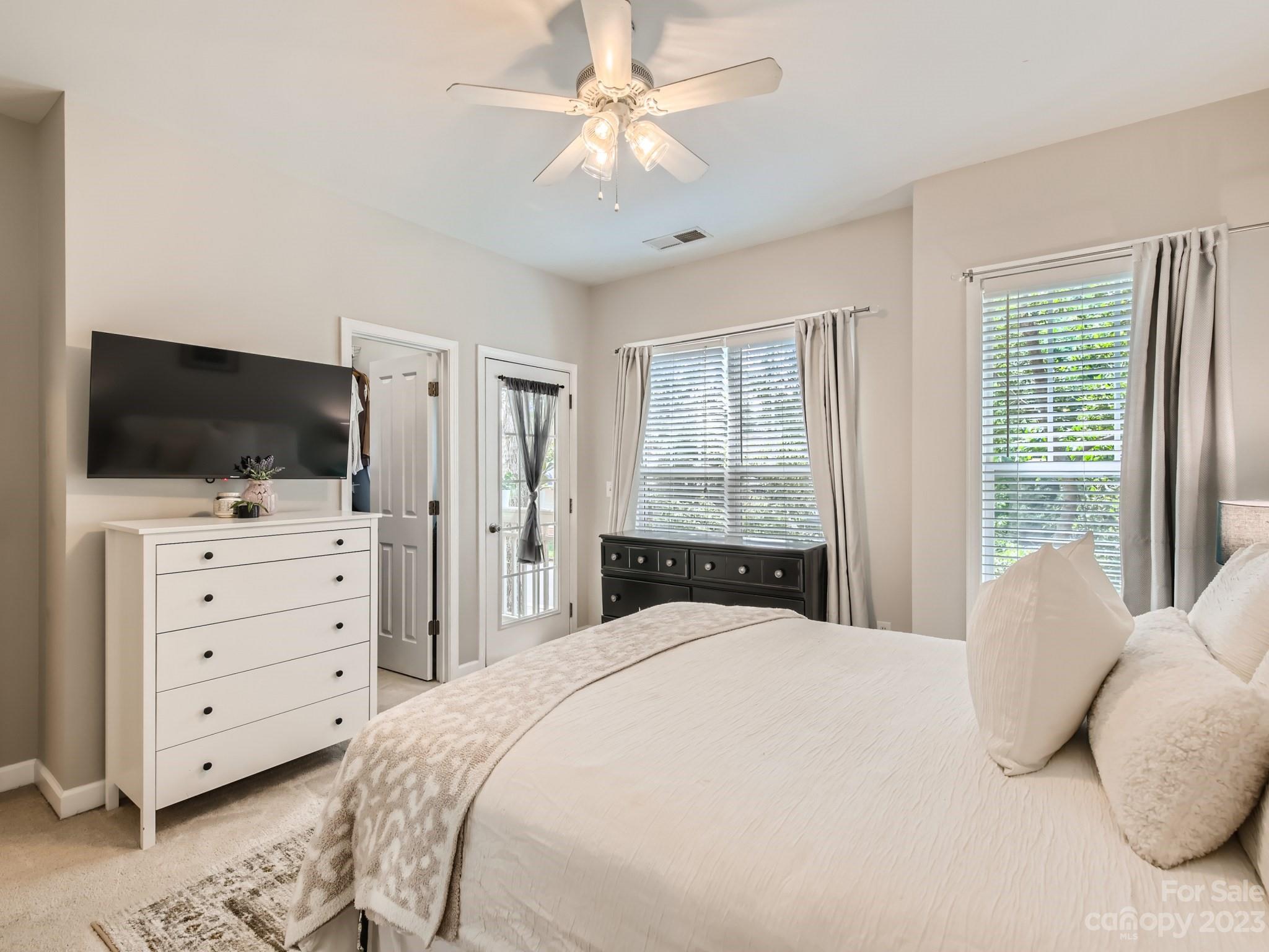 831 Millbrook Road Charlotte, NC 28211 - Photo 17 of 33 a bedroom with a large bed and flat tv screen on dresser