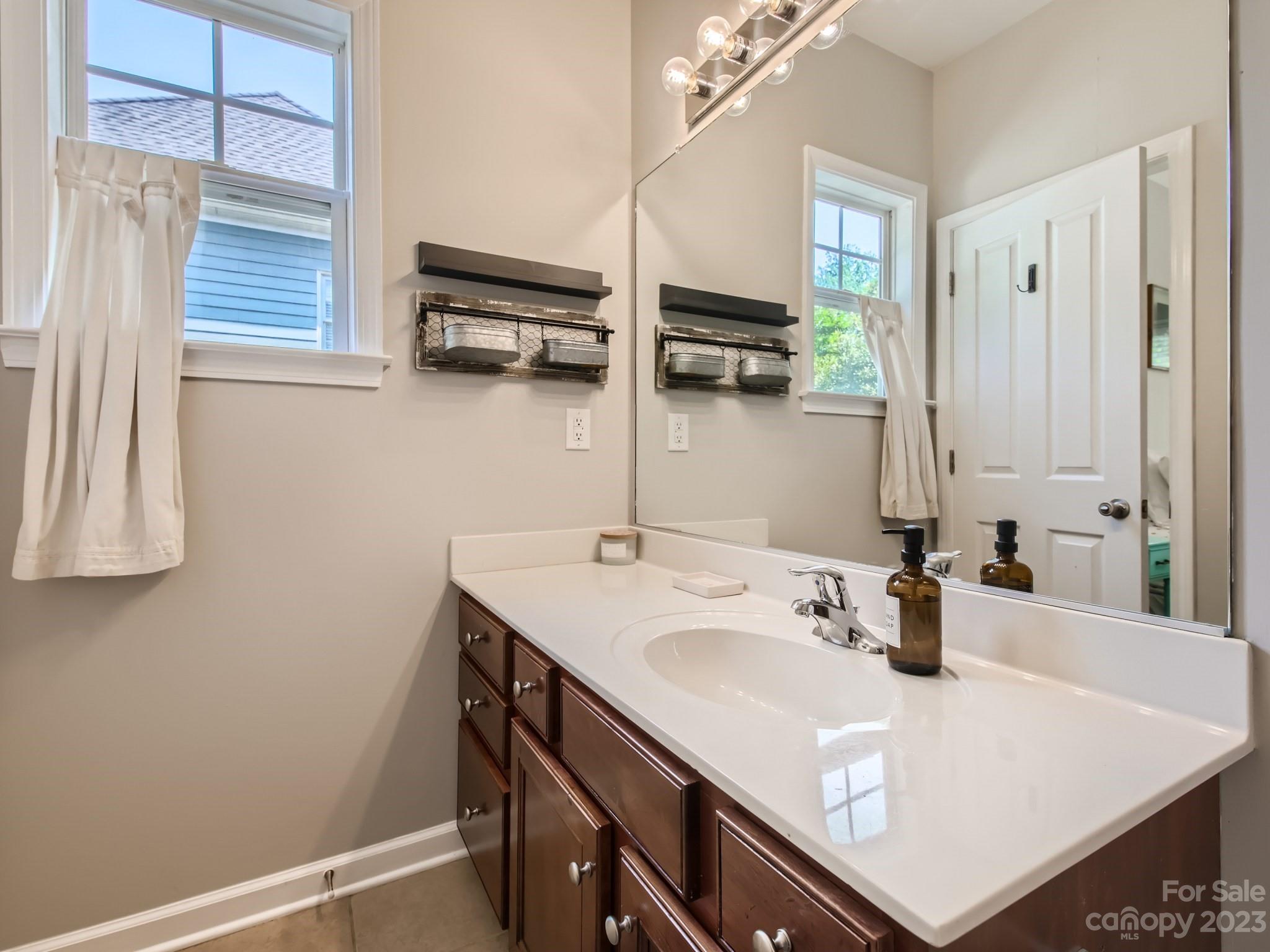 831 Millbrook Road Charlotte, NC 28211 - Photo 18 of 33 a bathroom with a sink and a mirror