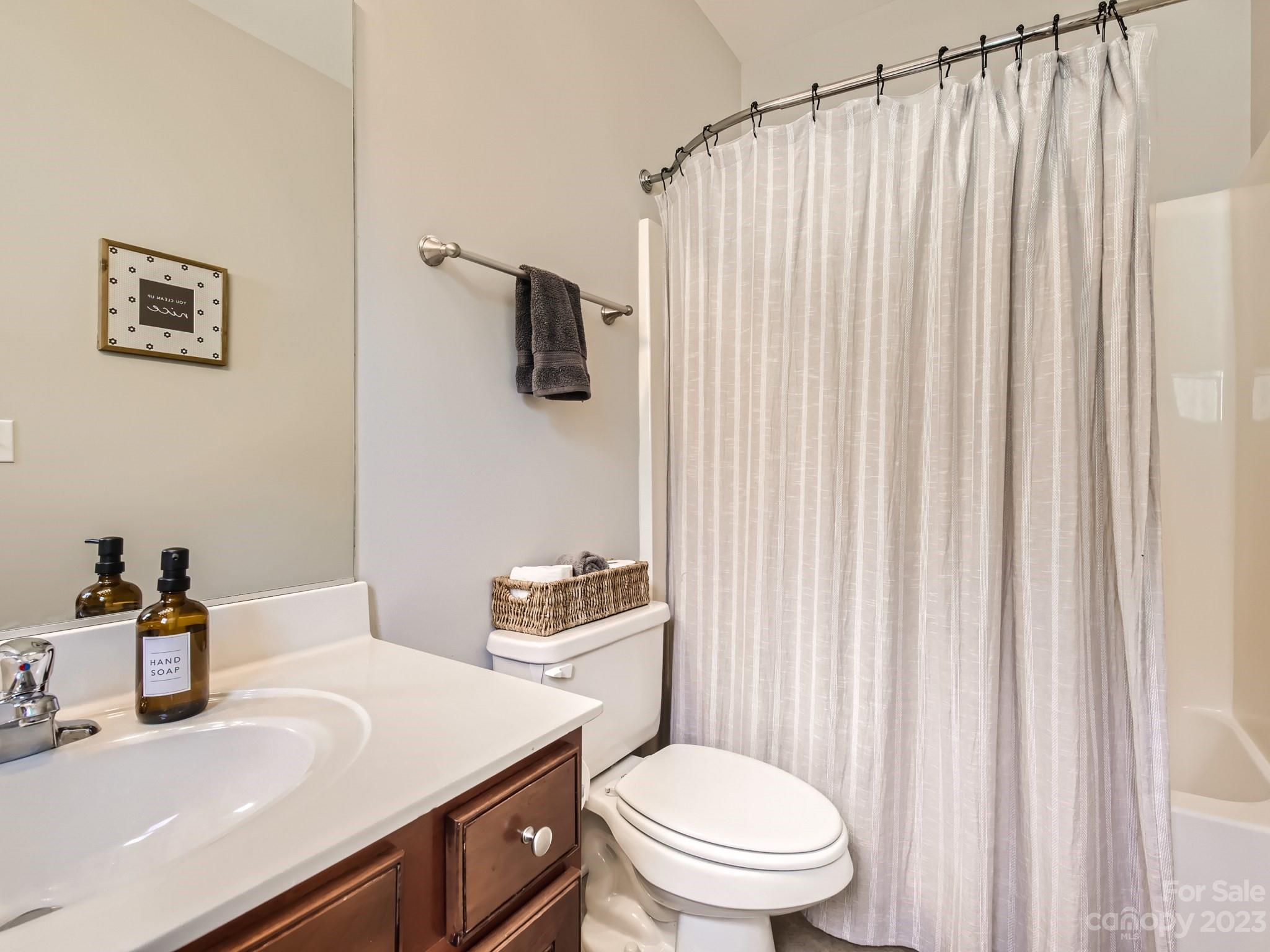 831 Millbrook Road Charlotte, NC 28211 - Photo 19 of 33 a bathroom with a sink a toilet and shower curtain