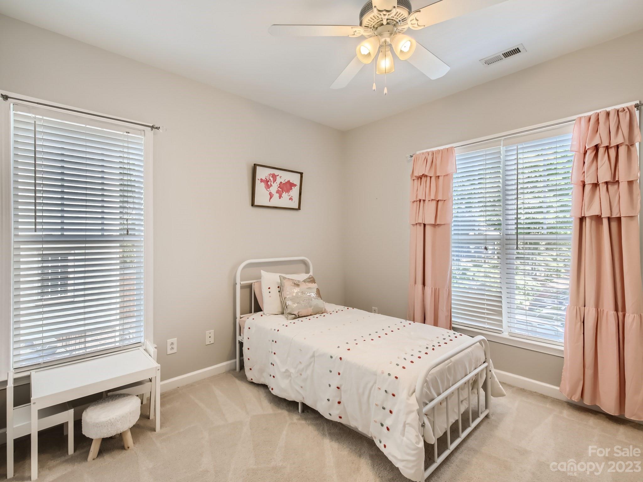 831 Millbrook Road Charlotte, NC 28211 - Photo 22 of 33 a bedroom with a large bed and a chandelier