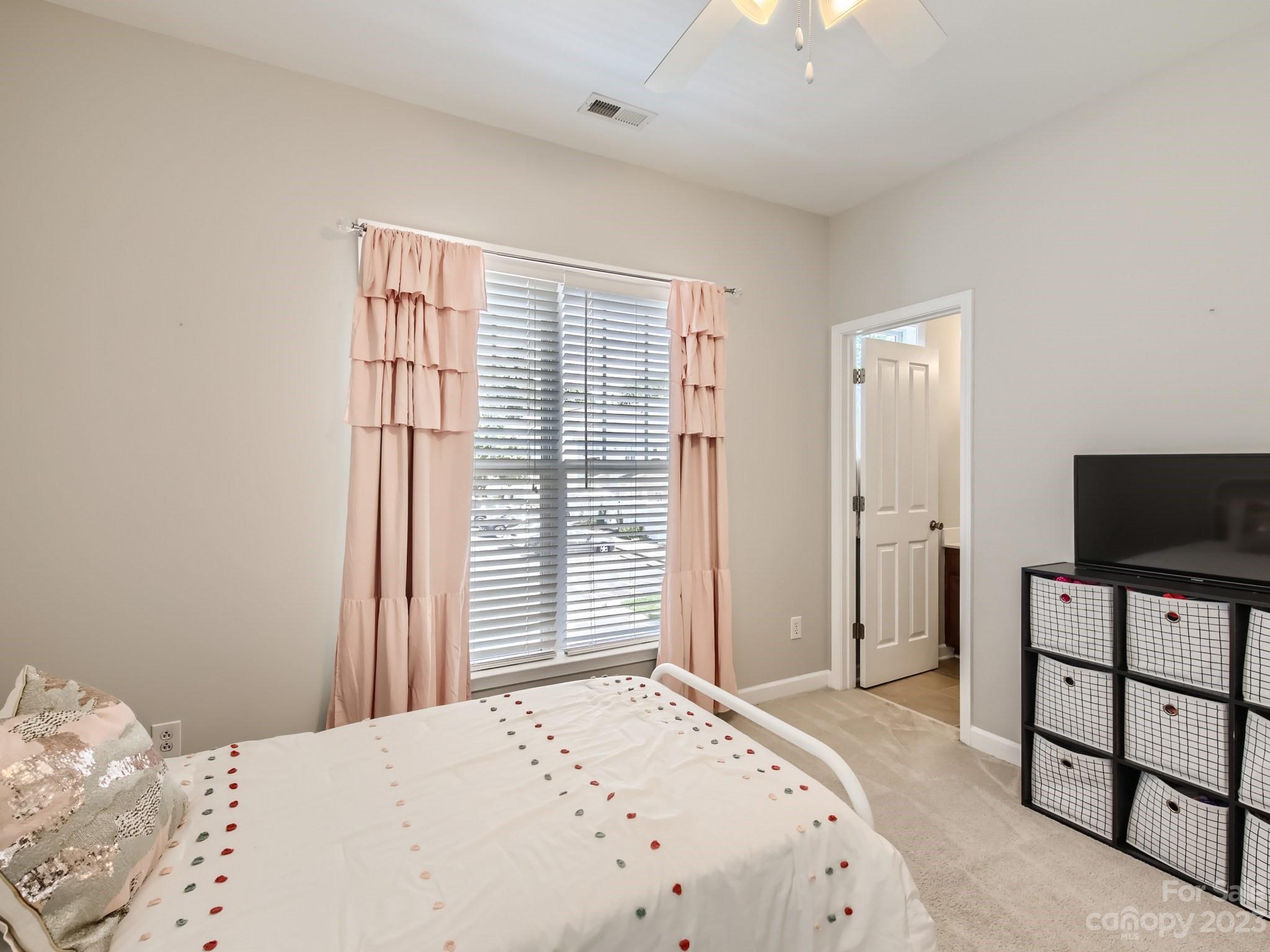 831 Millbrook Road Charlotte, NC 28211 - Photo 23 of 33 a bedroom with a bed and a flat screen tv