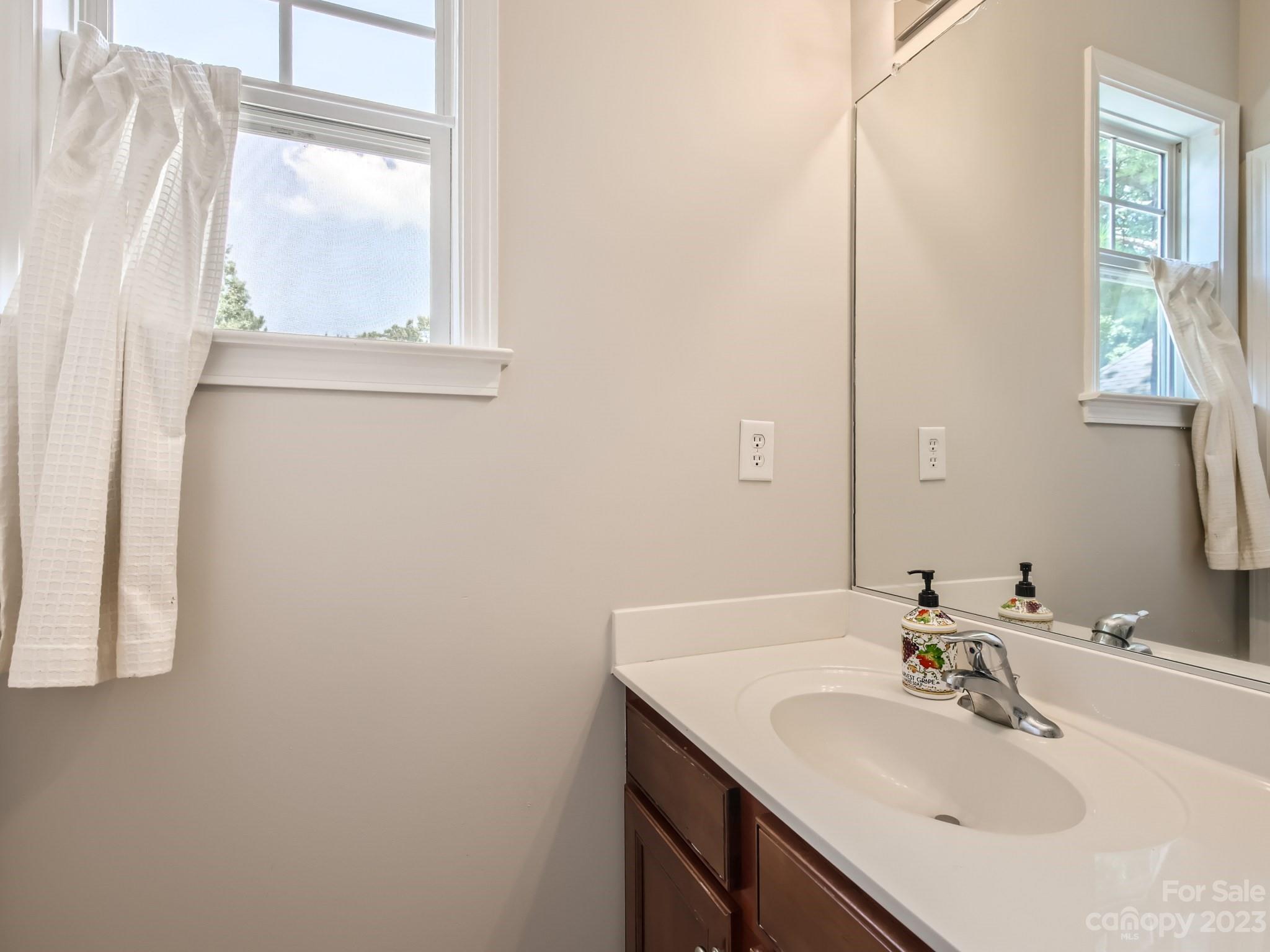831 Millbrook Road Charlotte, NC 28211 - Photo 24 of 33 a bathroom with a sink and a mirror
