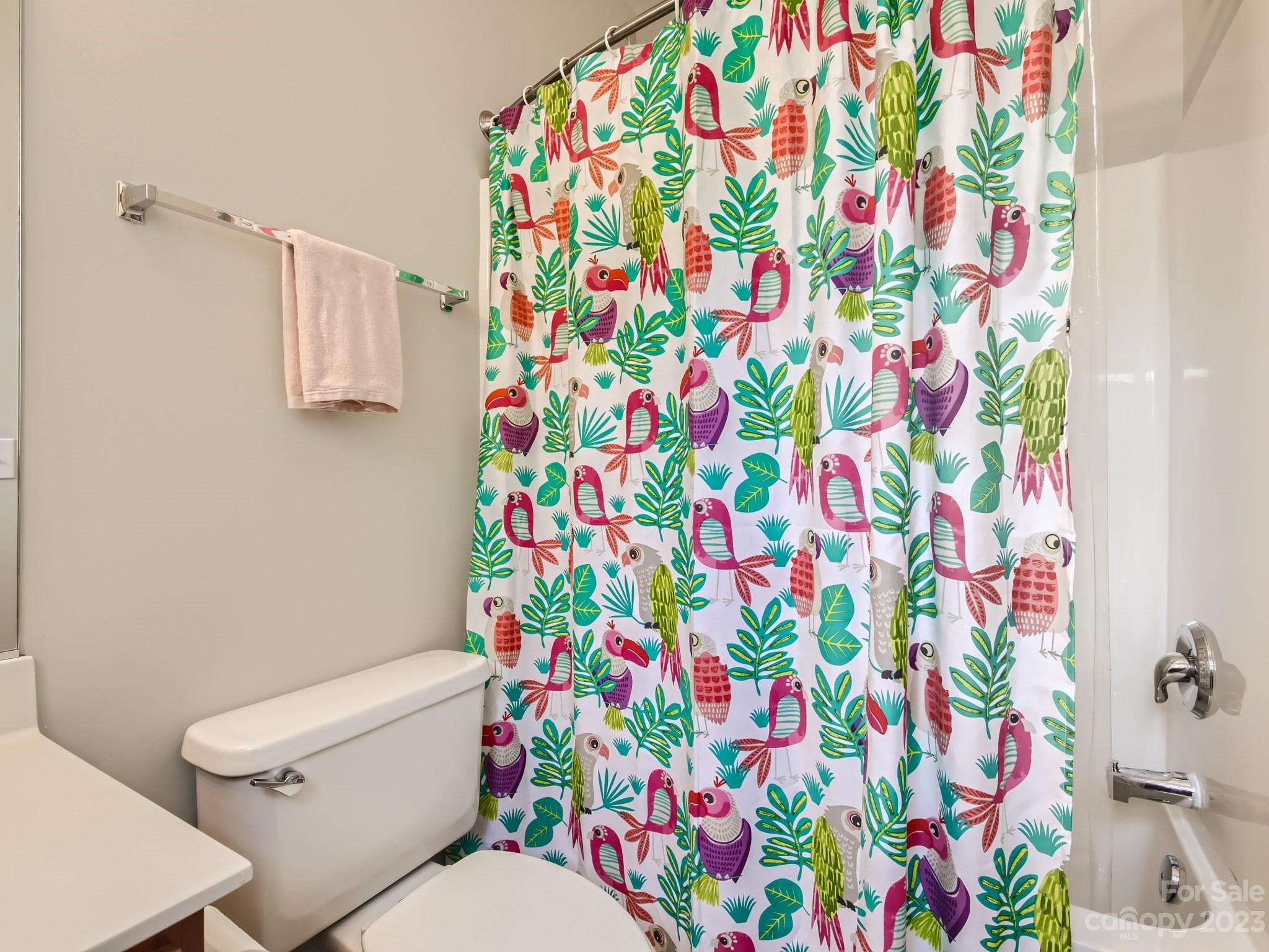 831 Millbrook Road Charlotte, NC 28211 - Photo 25 of 33 a white toilet sitting next to a shower curtain