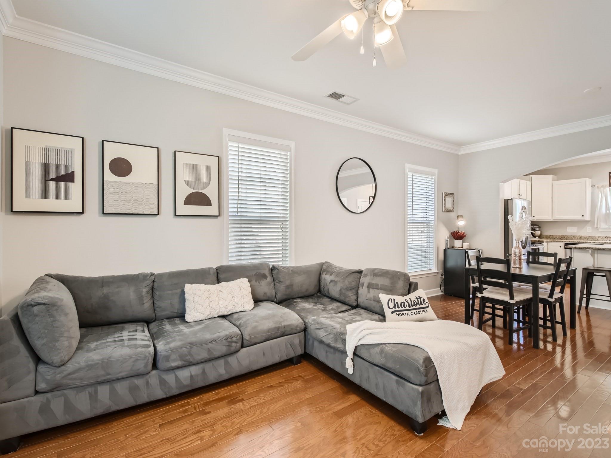 831 Millbrook Road Charlotte, NC 28211 - Photo 6 of 33 a living room with furniture a clock on wall and a window