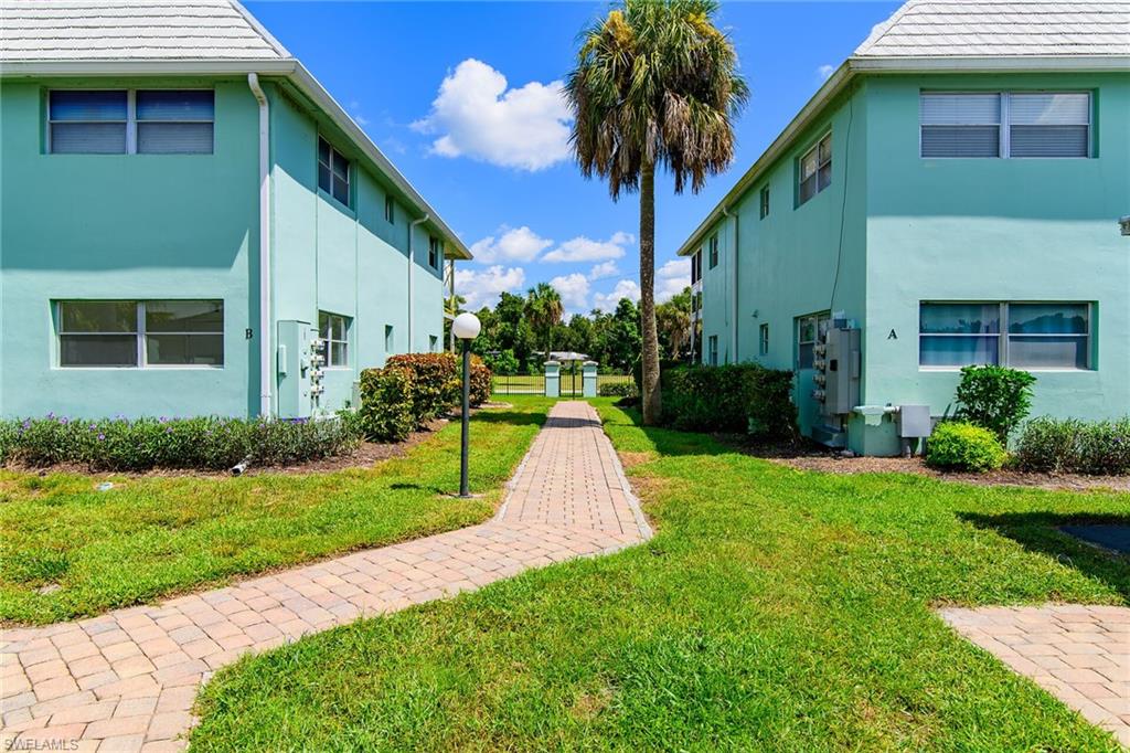 3225 East Riverside Drive Fort Myers, FL 33916 - Photo 19 of 33 a view of a house with a yard and potted plants