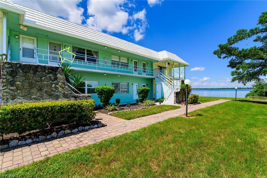 3225 East Riverside Drive Fort Myers, FL 33916 - Photo 20 of 33 a view of a house with a yard and potted plants