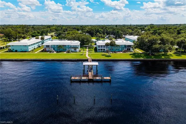 a aerial view of a house with swimming pool outdoor seating and yard