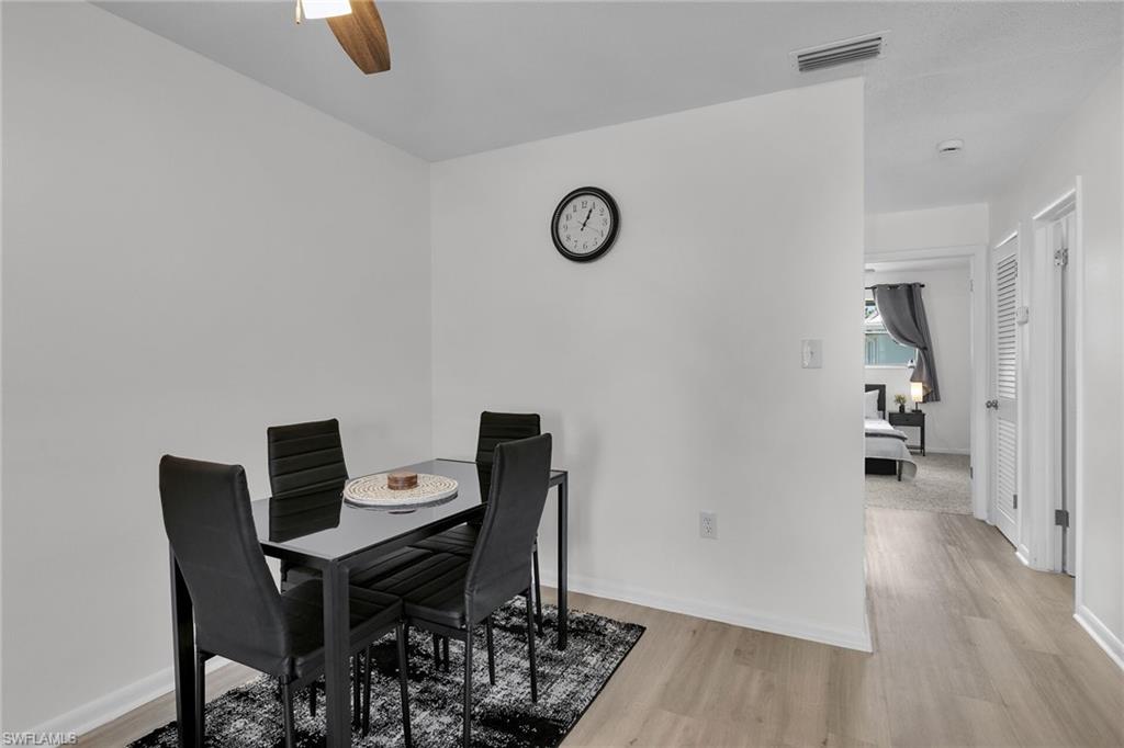 3225 East Riverside Drive Fort Myers, FL 33916 - Photo 6 of 33 a view of a workspace with furniture and wooden floor