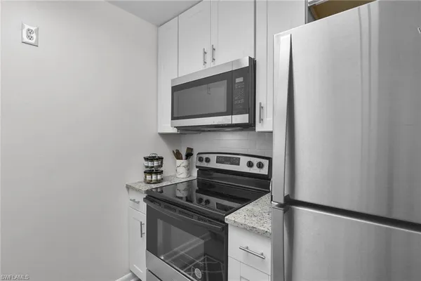 a kitchen with granite countertop cabinets and steel stainless steel appliances