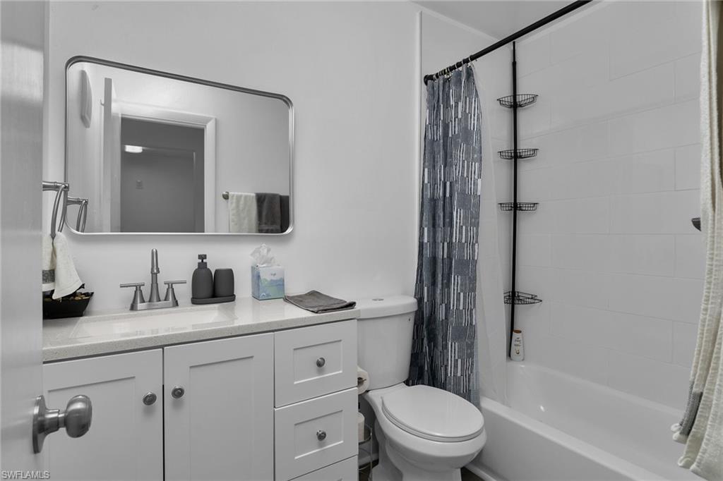 3225 East Riverside Drive Fort Myers, FL 33916 - Photo 10 of 33 a bathroom with a sink a toilet and shower
