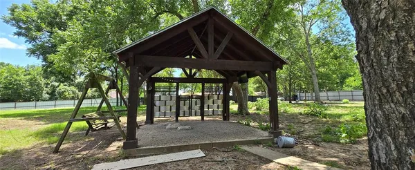 a view of a house with backyard and a sitting area