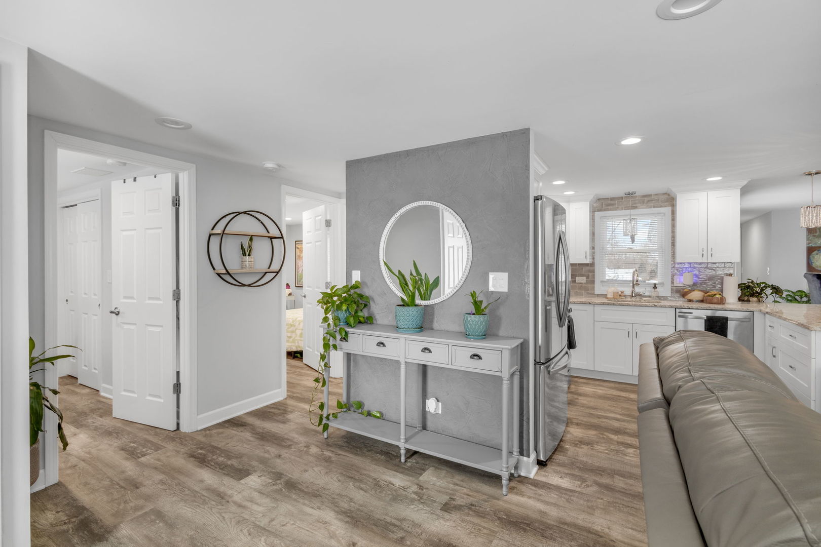 16446 West 147th Place Lockport, IL 60441 - Photo 2 of 22 a living room with furniture a mirror and kitchen view