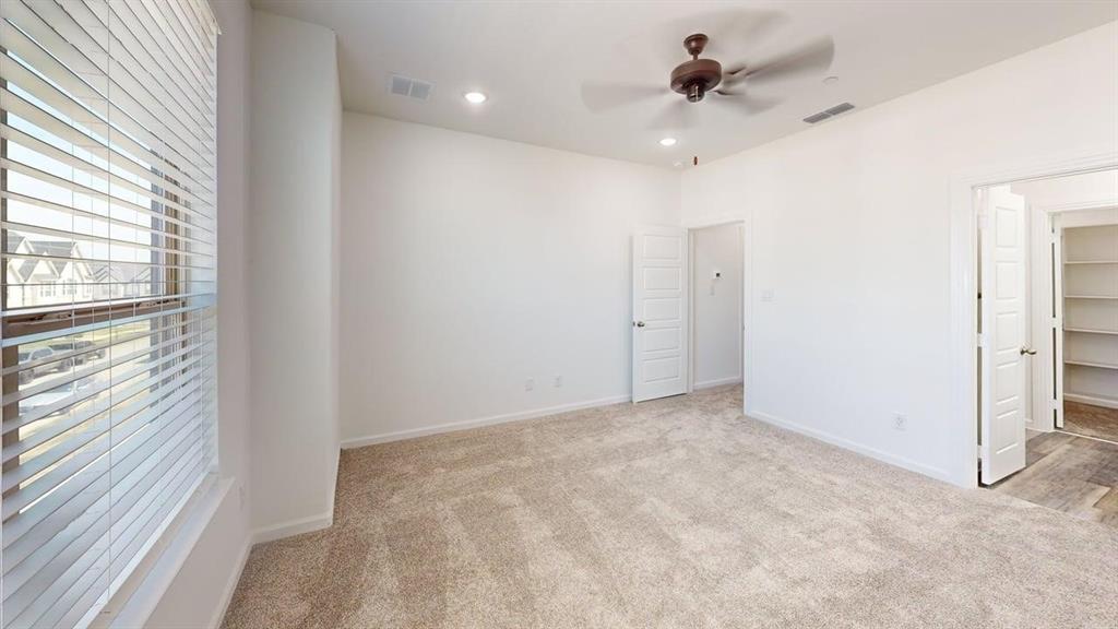 285 Buck Ridge Drive Frisco, TX 75068 - Photo 10 of 20 Unfurnished bedroom with light colored carpet, a spacious closet, a ceiling fan, and recessed lighting