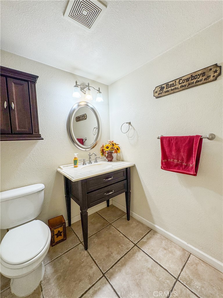 741 Ocotillo Road Blythe, CA 92225 - Photo 12 of 19 a bathroom with a toilet a sink and a mirror