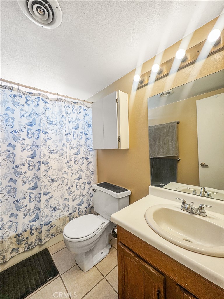 741 Ocotillo Road Blythe, CA 92225 - Photo 18 of 19 a bathroom with a sink a toilet and a mirror