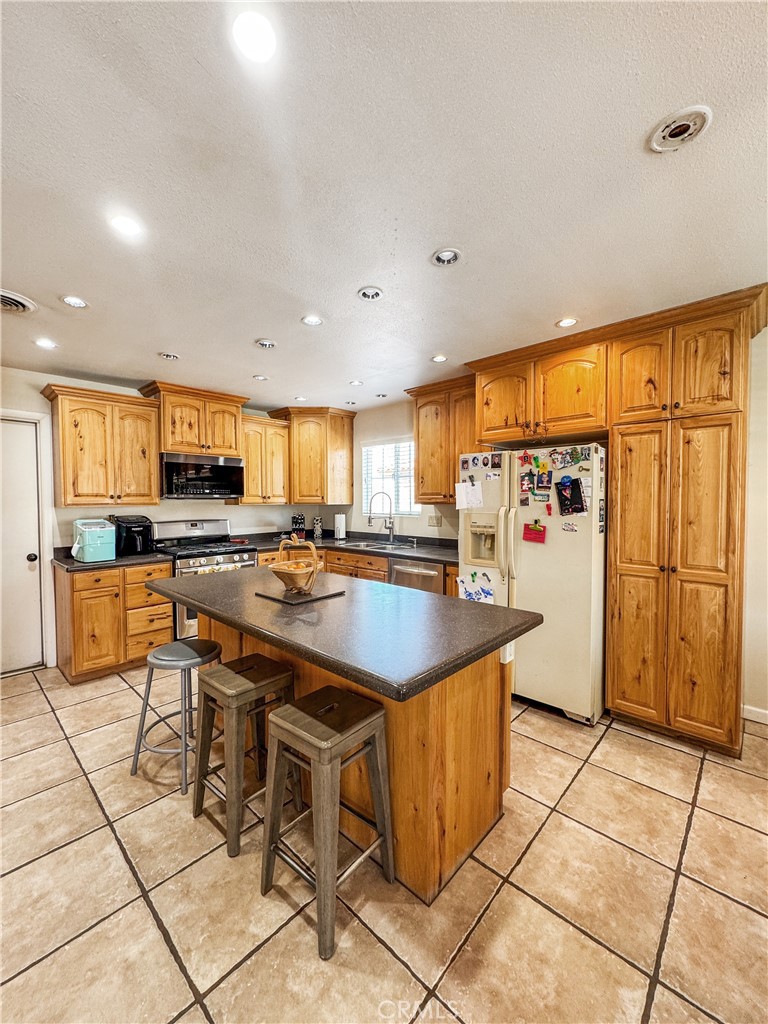 741 Ocotillo Road Blythe, CA 92225 - Photo 3 of 19 a kitchen with stainless steel appliances granite countertop a refrigerator and a stove top oven