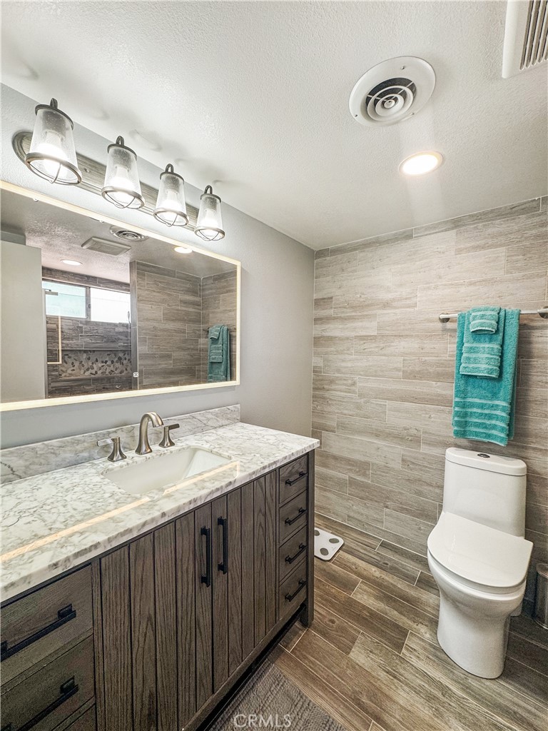 741 Ocotillo Road Blythe, CA 92225 - Photo 5 of 19 a bathroom with a granite countertop toilet sink and mirror