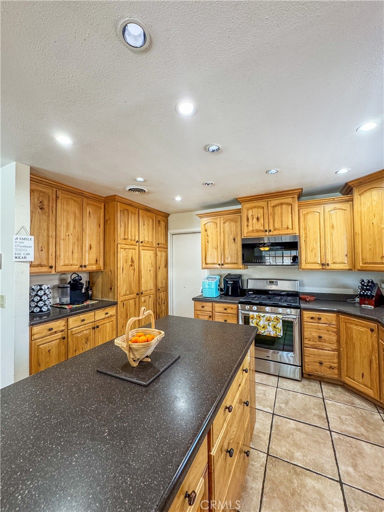 741 Ocotillo Road Blythe, CA 92225 - Photo 7 of 19 a kitchen with stainless steel appliances granite countertop a stove top oven a sink a counter space and cabinets
