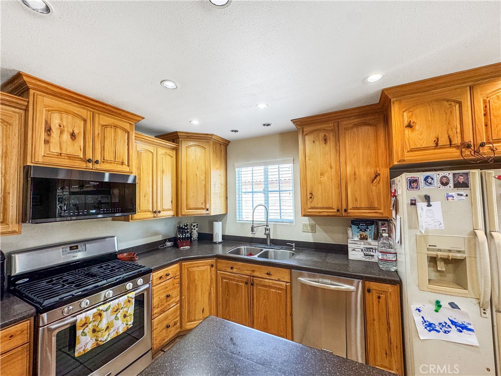 741 Ocotillo Road Blythe, CA 92225 - Photo 8 of 19 a kitchen with stainless steel appliances granite countertop a stove a sink and a refrigerator