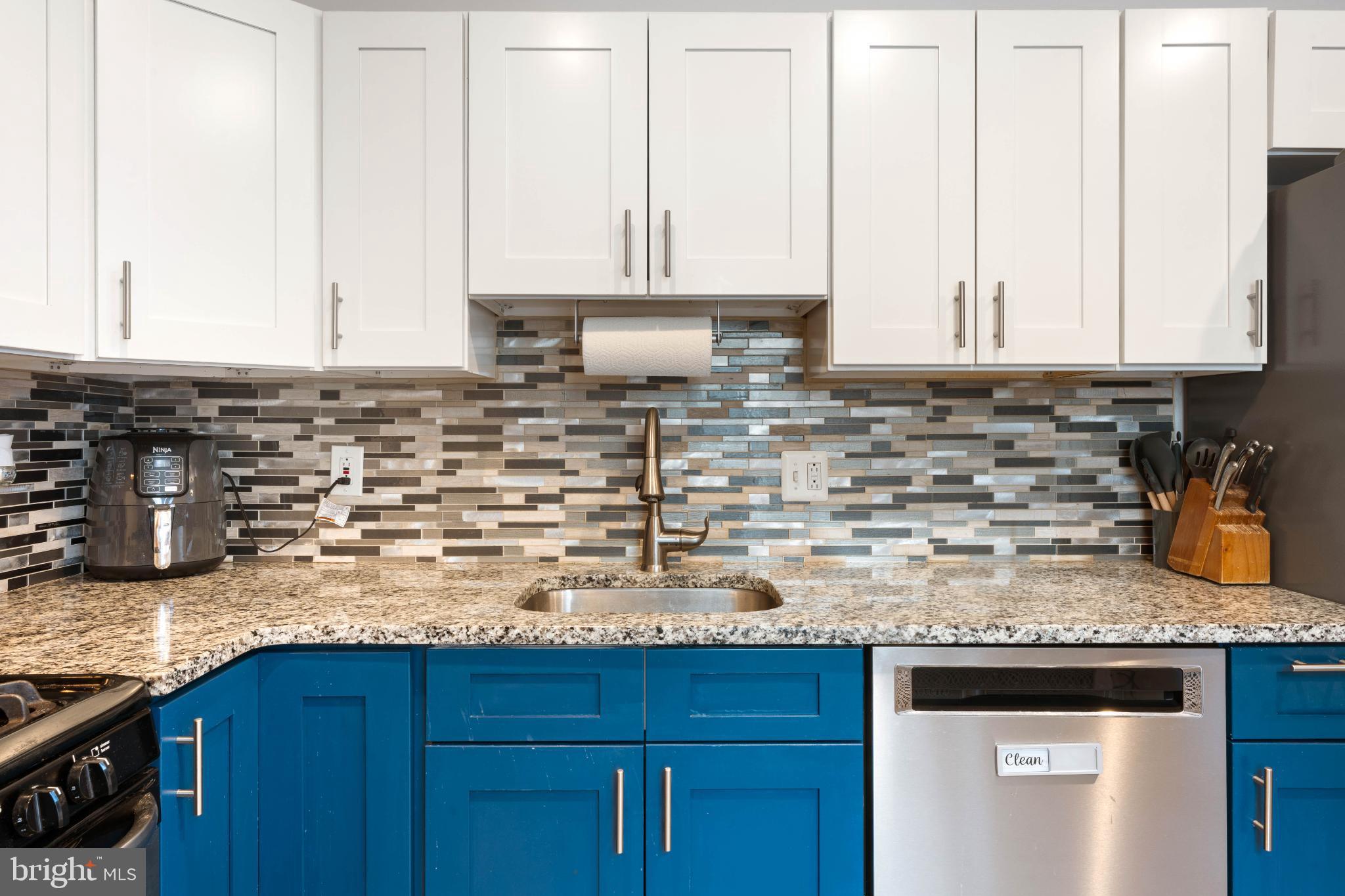 4618 Smick Street Philadelphia, PA 19127 - Photo 12 of 32 a kitchen with granite countertop a sink a stove and cabinets