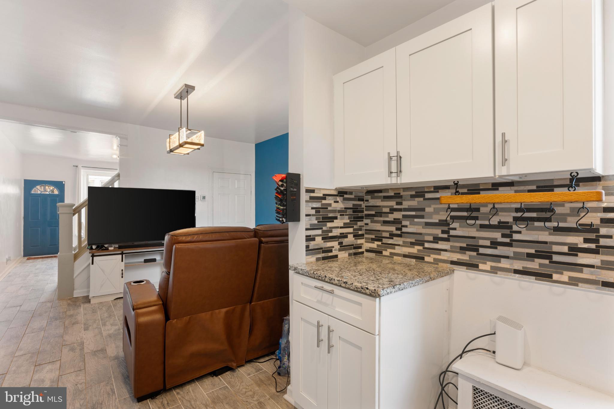 4618 Smick Street Philadelphia, PA 19127 - Photo 14 of 32 a kitchen with granite countertop a sink and a stove top oven