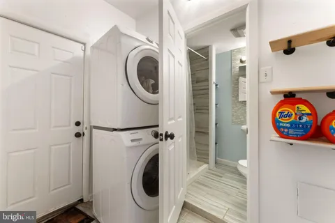 a view of a hallway with washer and dryer